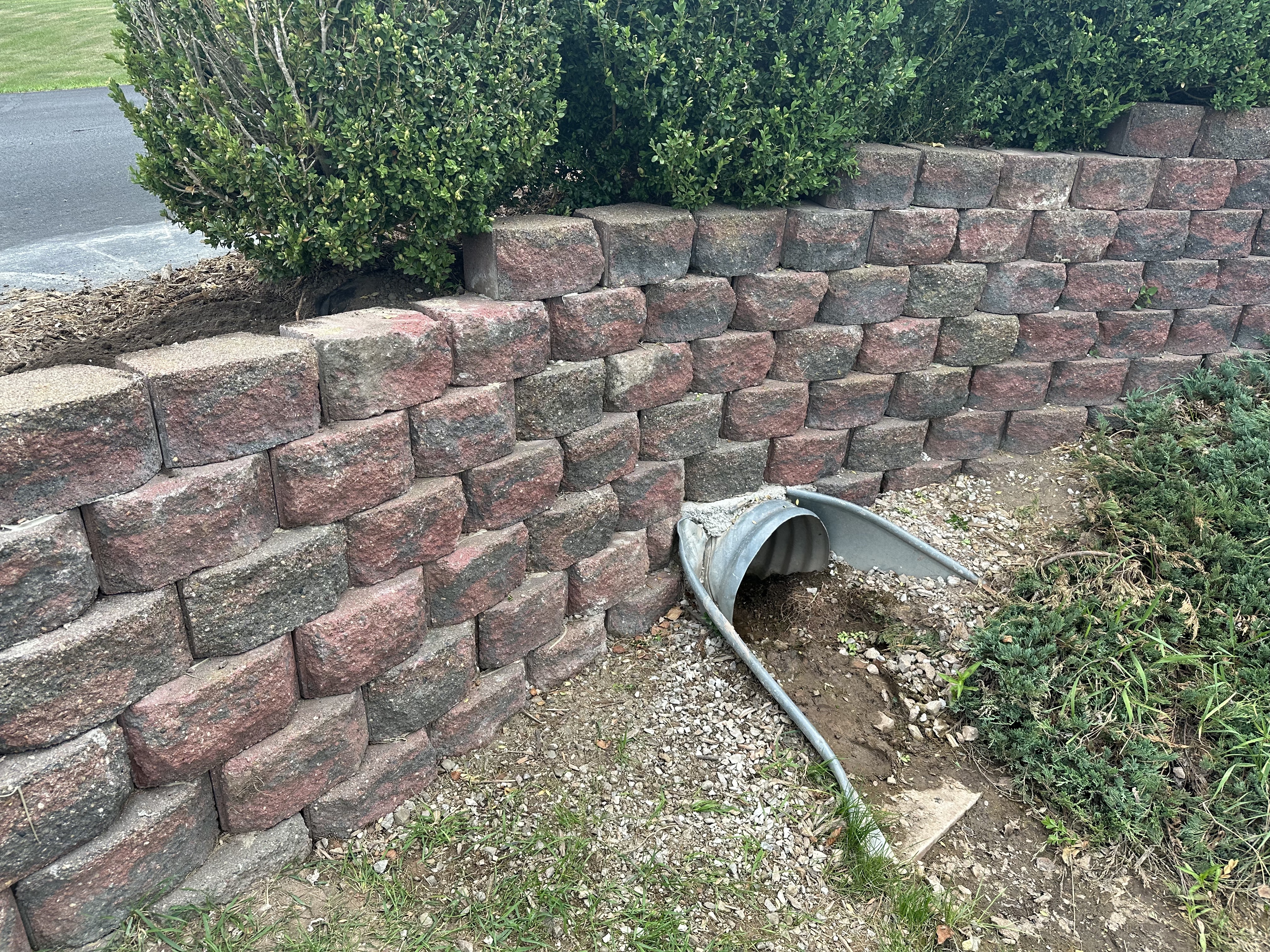 Retaining wall installation on a landscaped property
